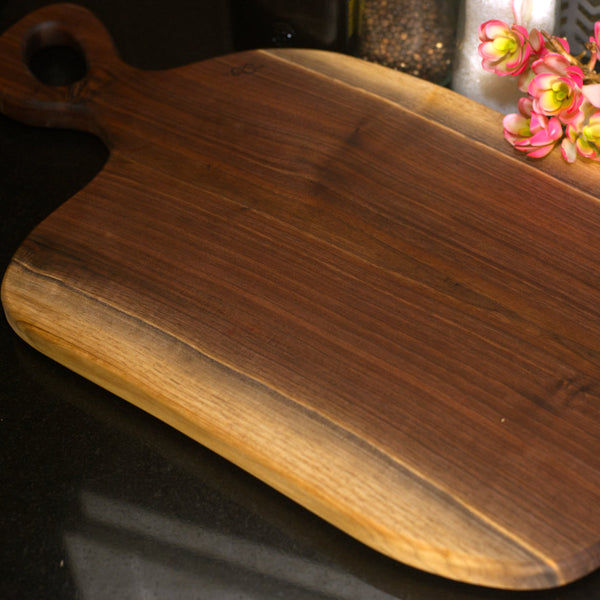 Figure 8 Woodworking Bow charcuterie board made with live-edge walnut wood