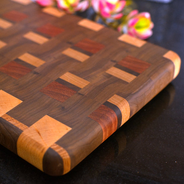 Figure 8 Woodworking Chinook cutting board made with end-grain maple, cherry, padauk and walnut wood in a random checkered pattern