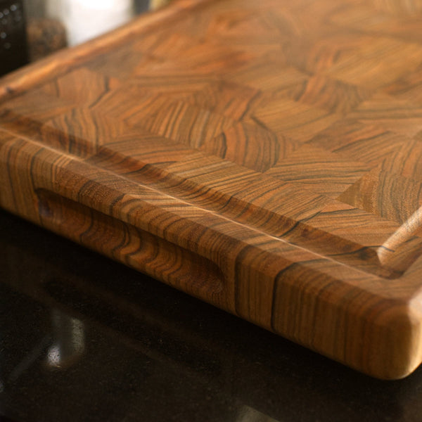 Figure 8 Woodworking Yamnuska cutting board or butcher block made with end-grain shedua wood showing a juice groove and a finger groove on the short side