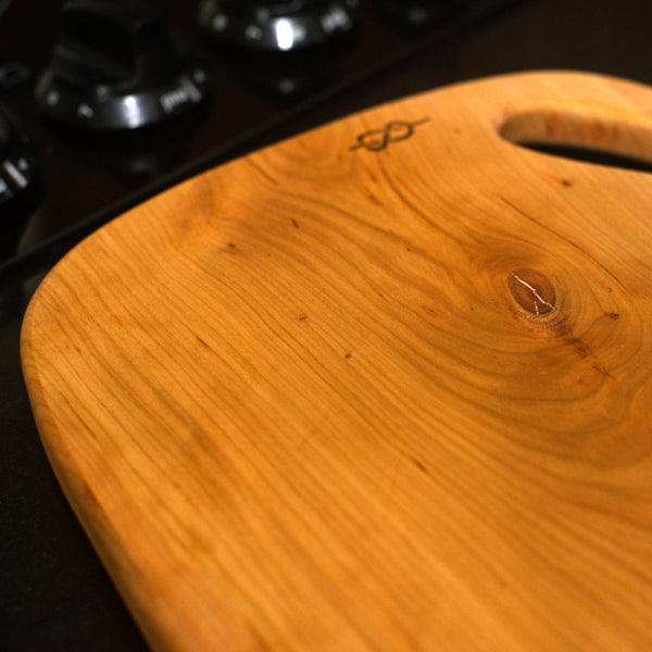 Figure 8 Woodworking Yoho charcuterie board made with live-edge cherry wood